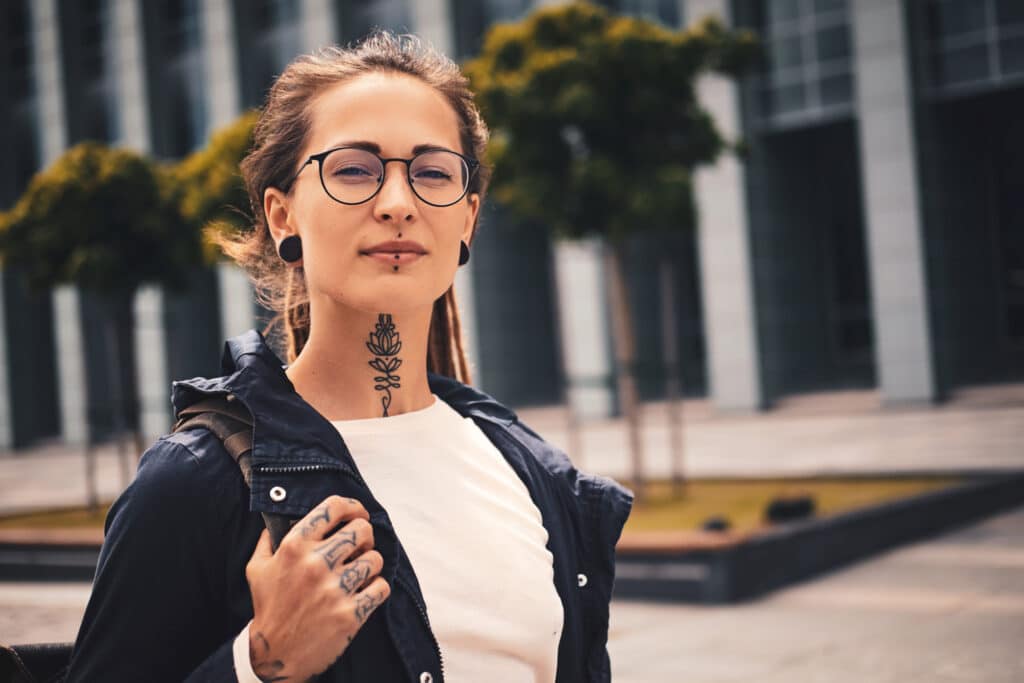 Tattooed woman walks confidently down the stress