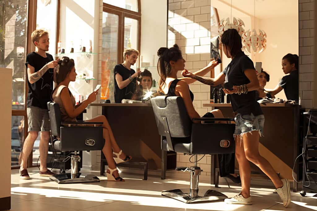 Booth renter working alongside staff at a busy salon