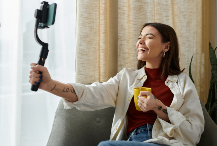 Young tattooed girls smiles as she records an Instagram story as part of her Marketing Strategies for her Tattoo Studio